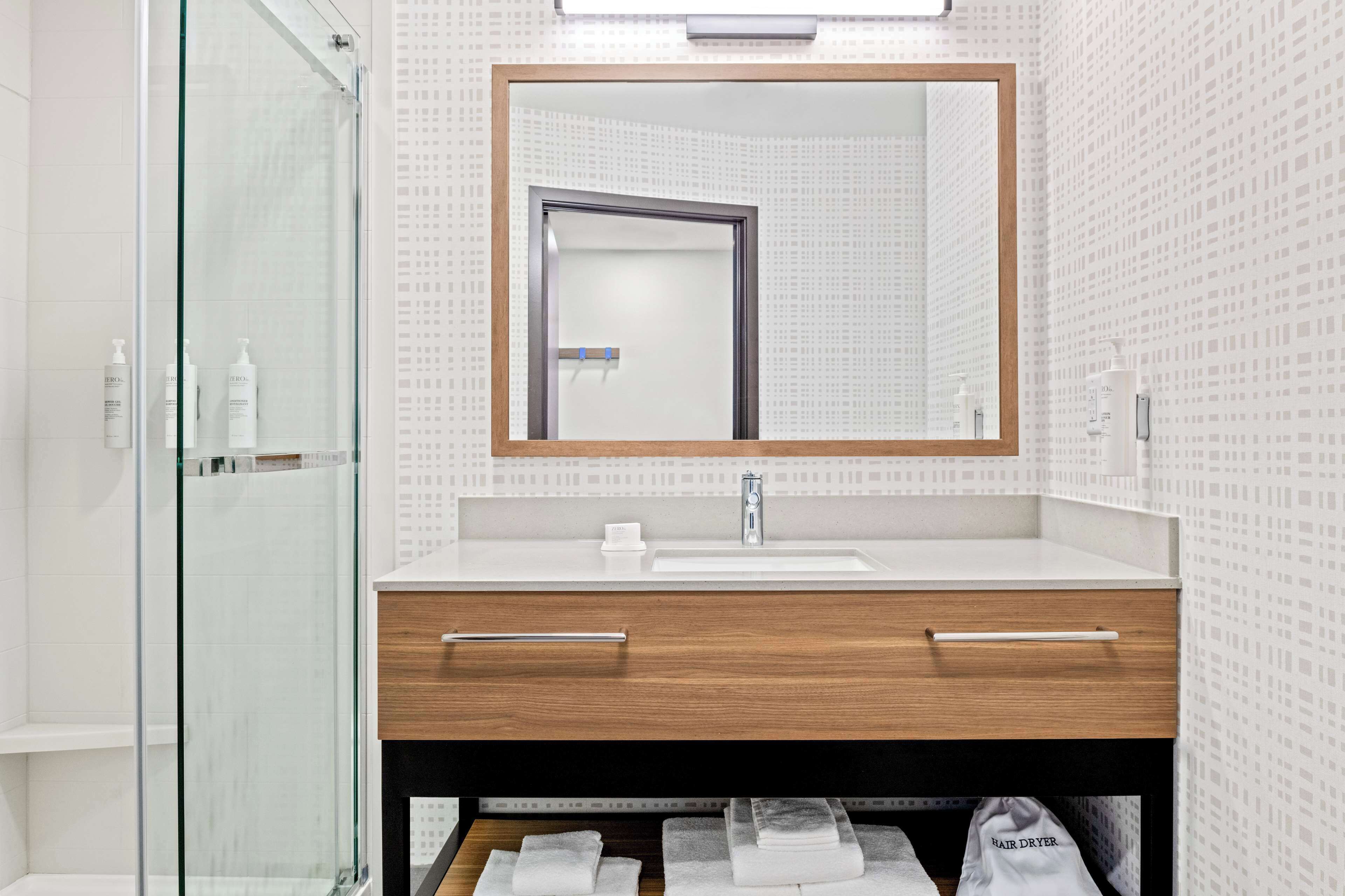 designer toiletries, hair dryer, towels