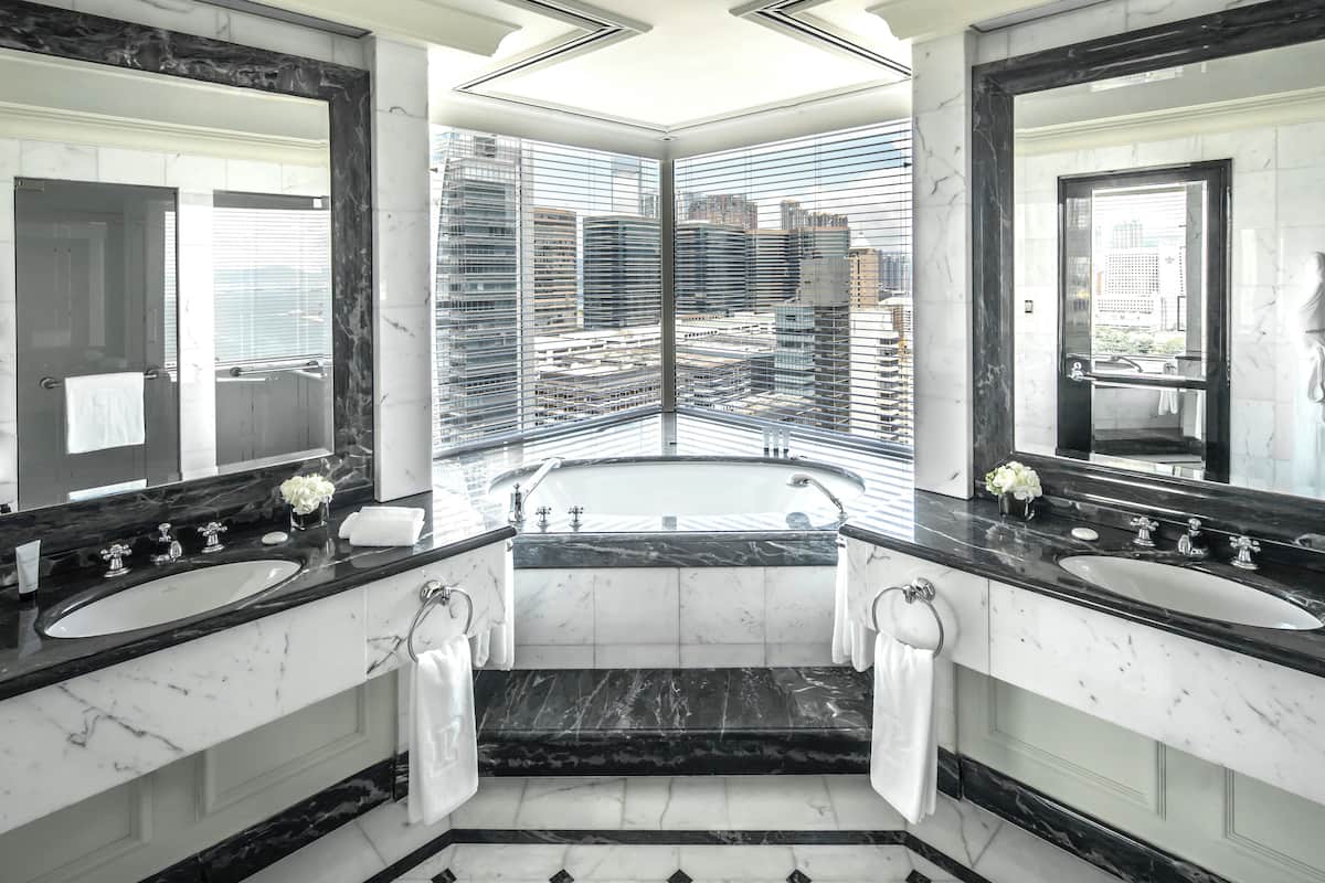 grand deluxe harbour view suite | bathroom | separate bathtub and shower, rainfall showerhead, designer toiletries
