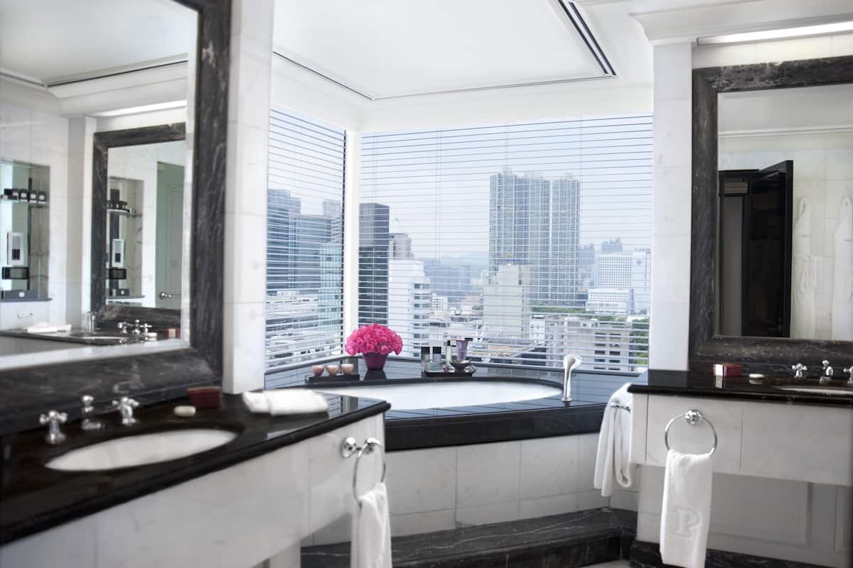 deluxe harbour view suite | bathroom | separate bathtub and shower, rainfall showerhead, designer toiletries