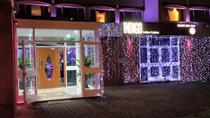 An exterior of an establishment with a sign reading "INDIGO Indian Cuisine." - Hylands Hotel (Coventry)