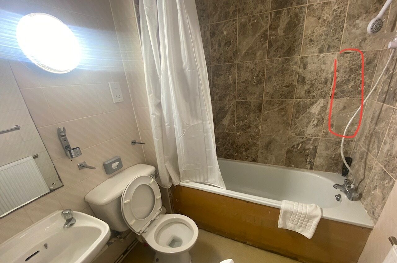 A bathroom with a bathtub, toilet, sink, and shower.