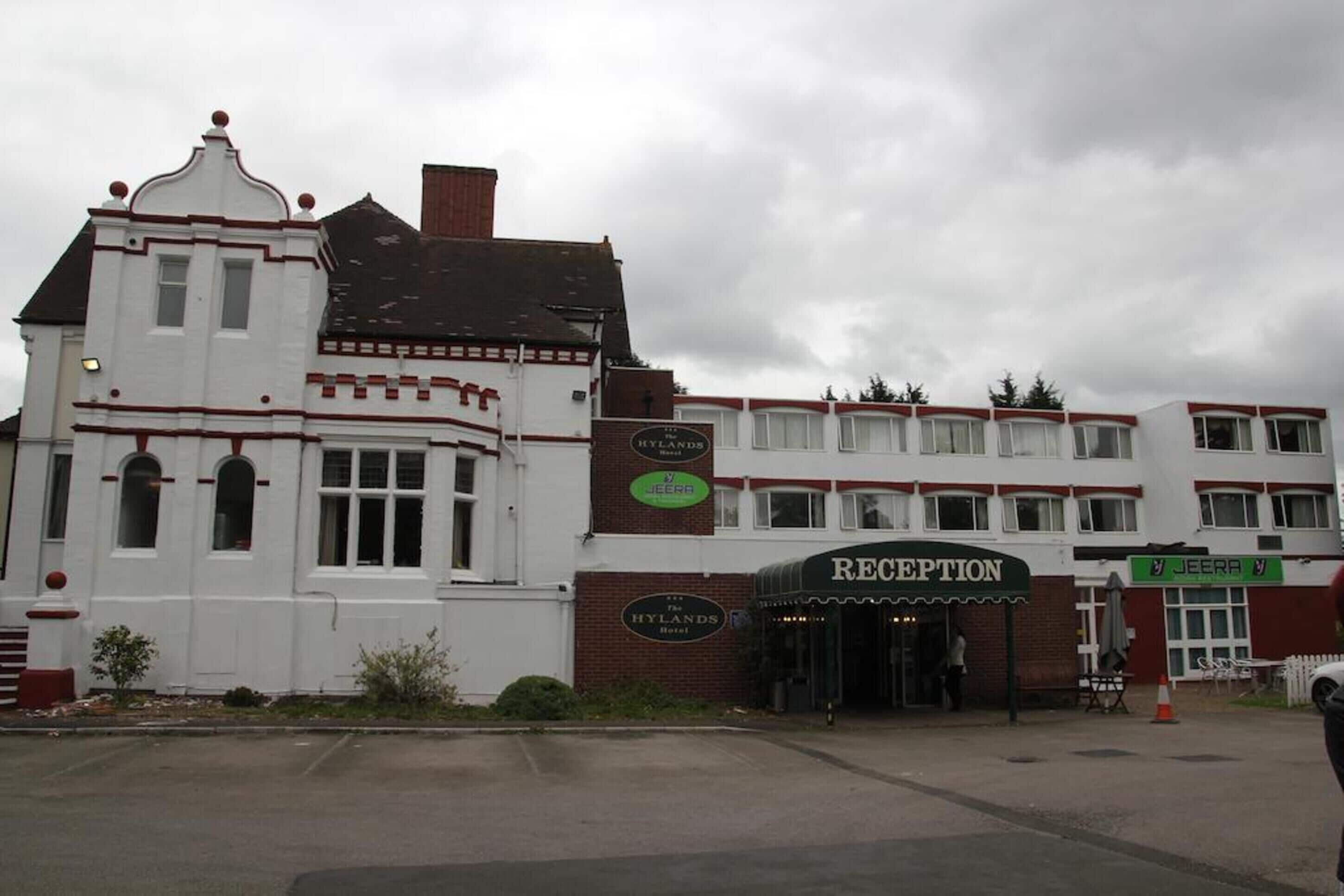 A hotel with a reception area, a sign for 'The Hylands Hotel', and a 'Jeera' sign.