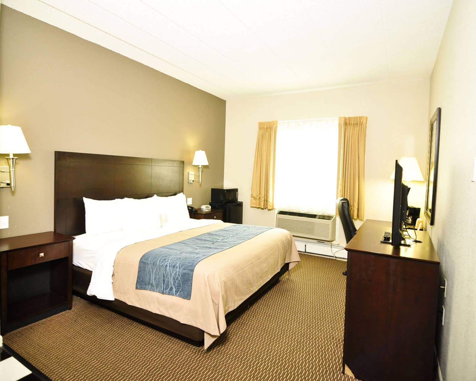 Premium bedding, desk, laptop workspace, blackout drapes