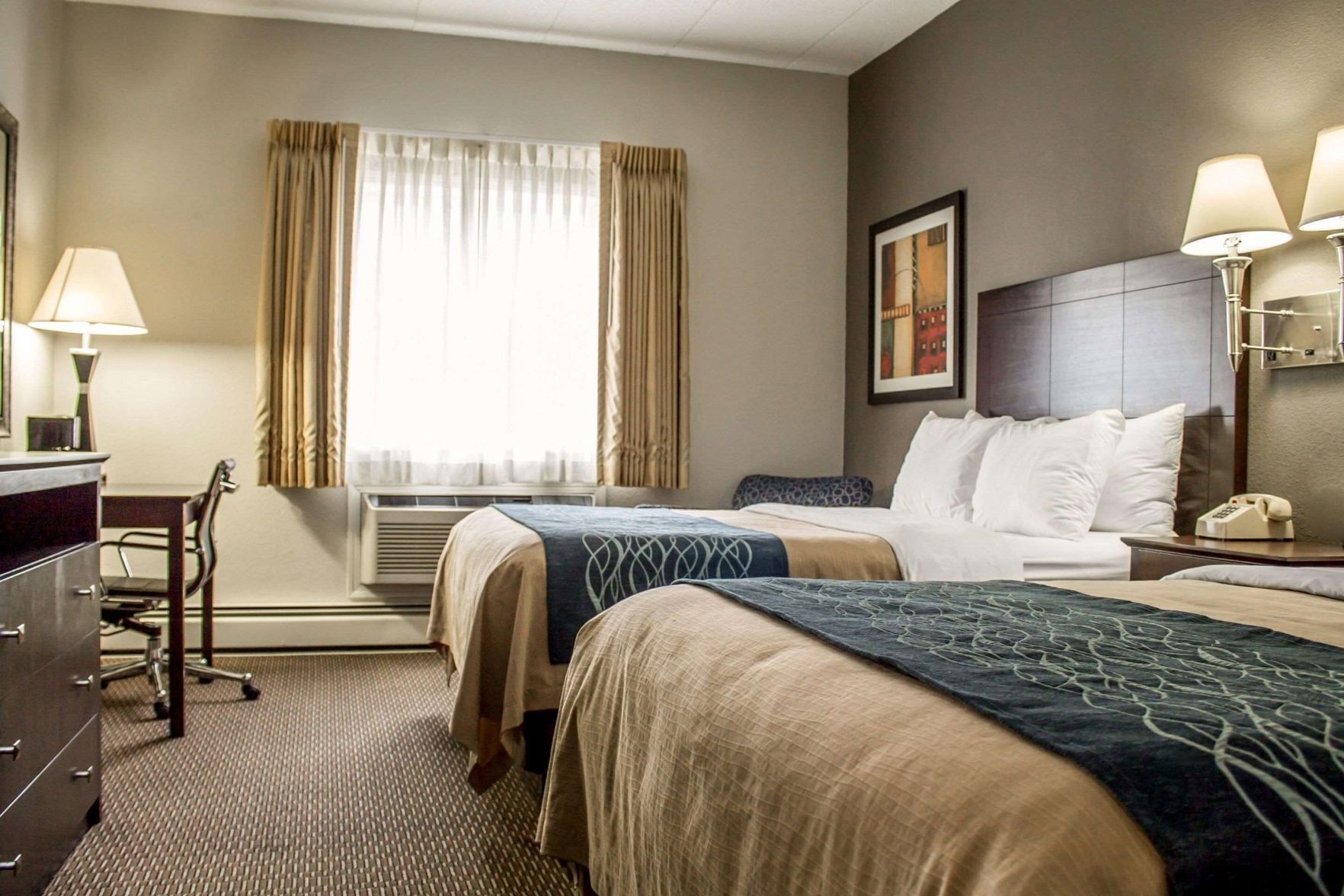 Premium bedding, desk, laptop workspace, blackout drapes