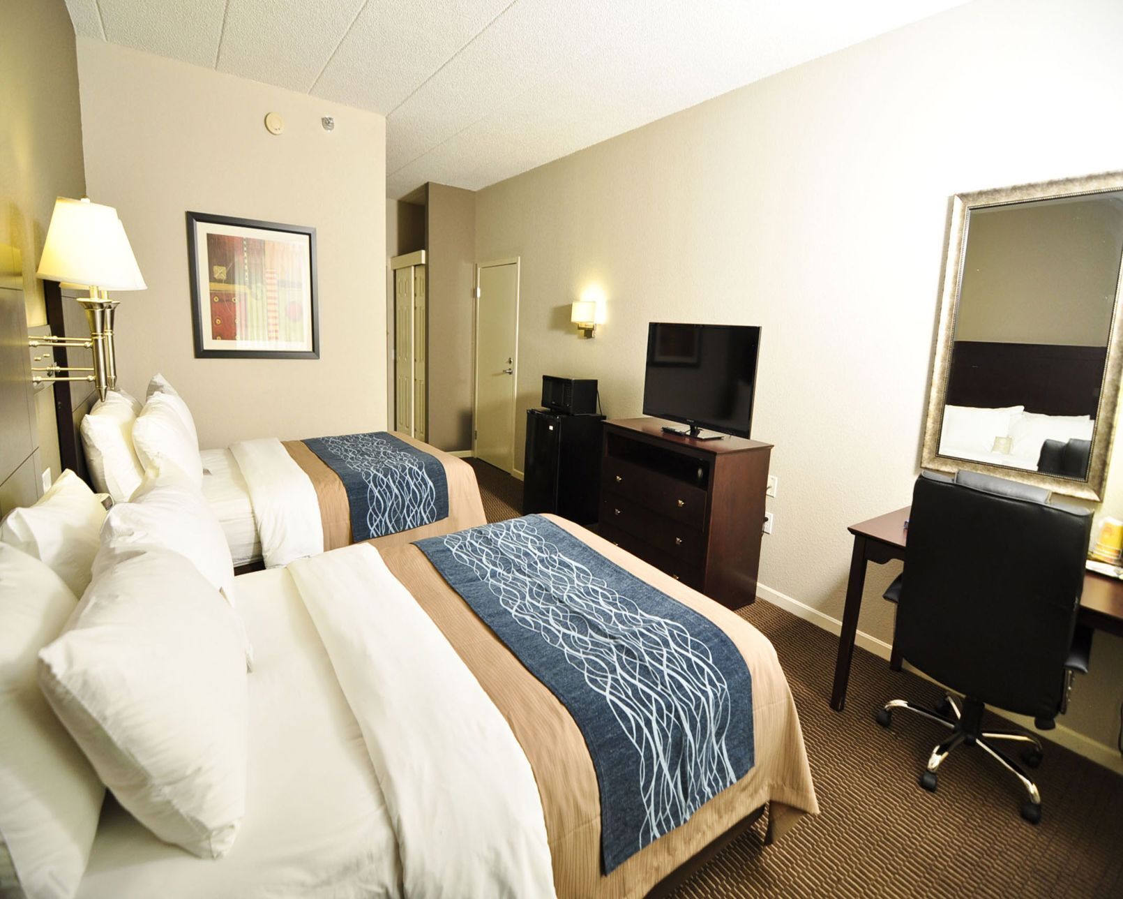Premium bedding, desk, laptop workspace, blackout drapes