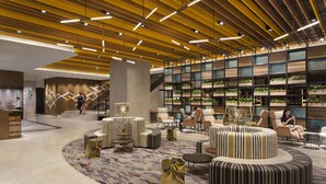 A modern lobby with a central seating area, a staircase, and a wall with greenery. - JEN Singapore Tanglin by Shangri-La (Singapore)