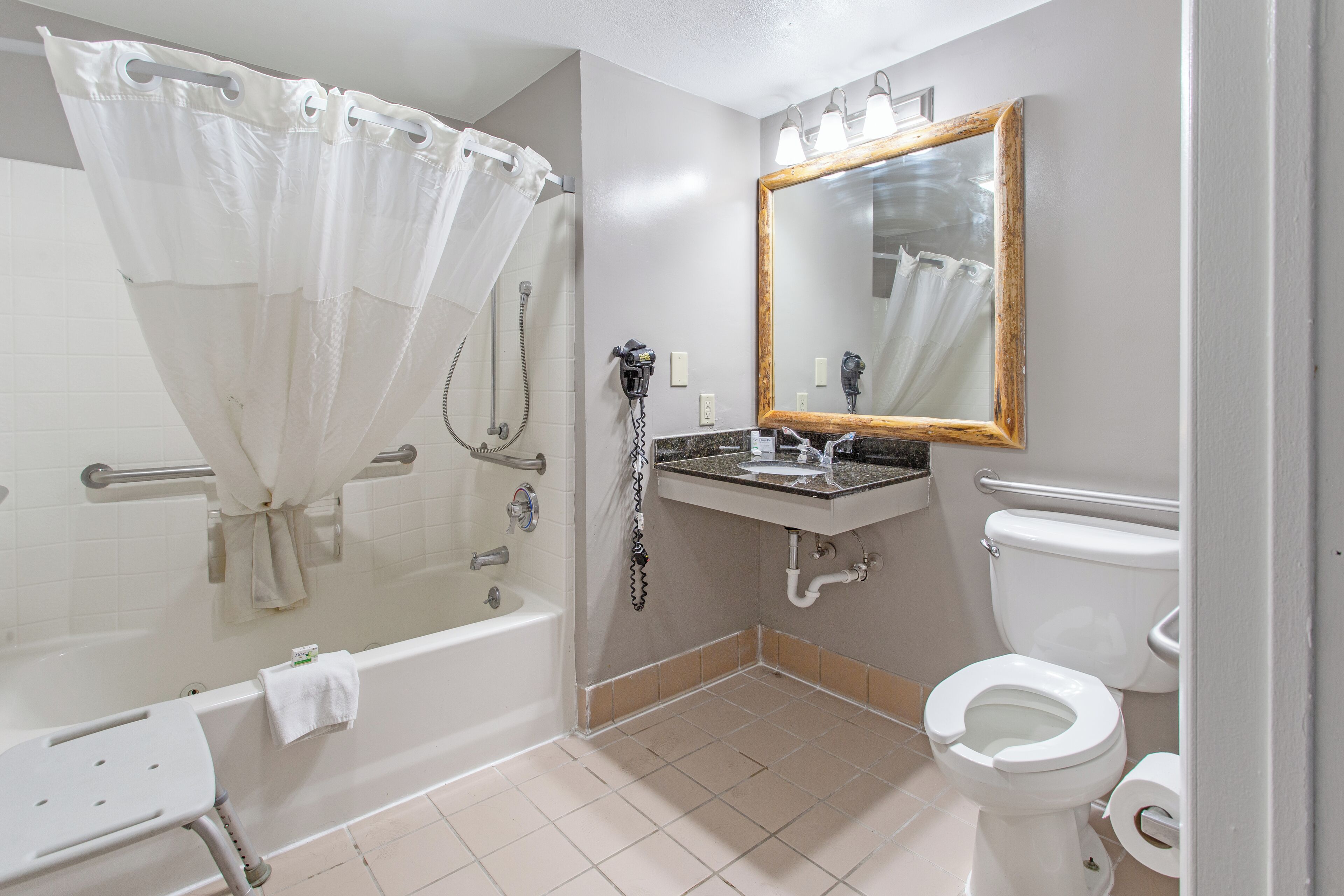 A bathroom with a bathtub, a shower, a sink, and a toilet.
