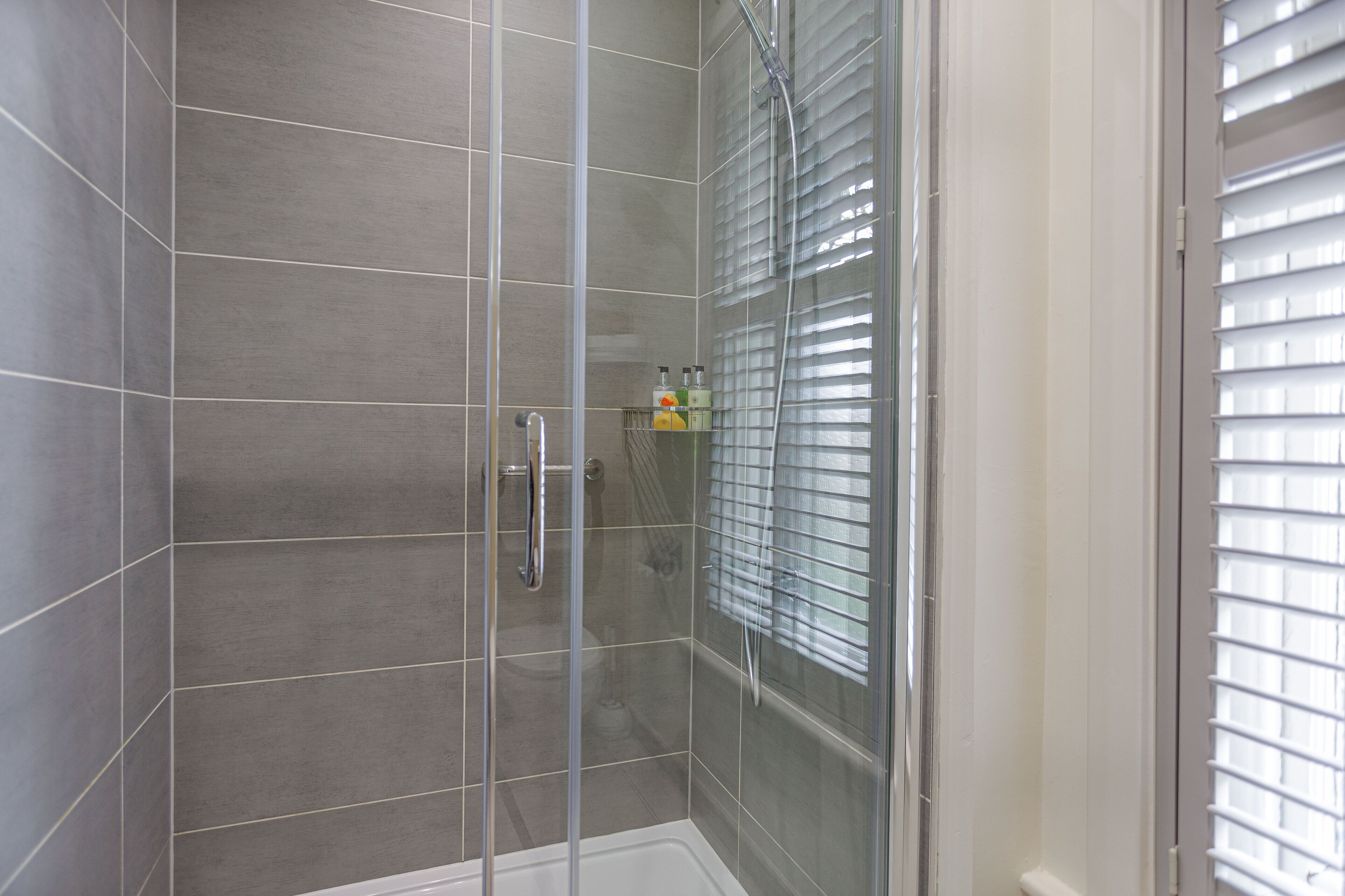 superior family room for 3 | bathroom | shower, eco-friendly toiletries, hair dryer, towels