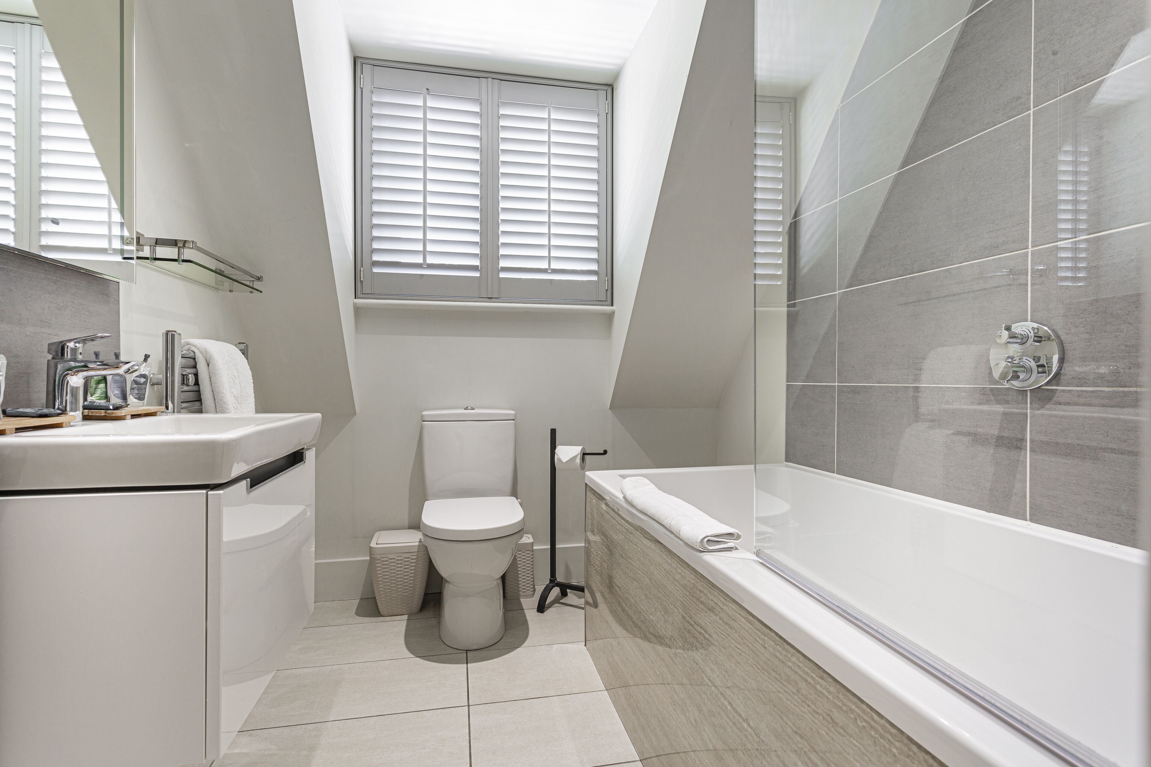 deluxe family room for 4 | bathroom | shower, eco-friendly toiletries, hair dryer, towels