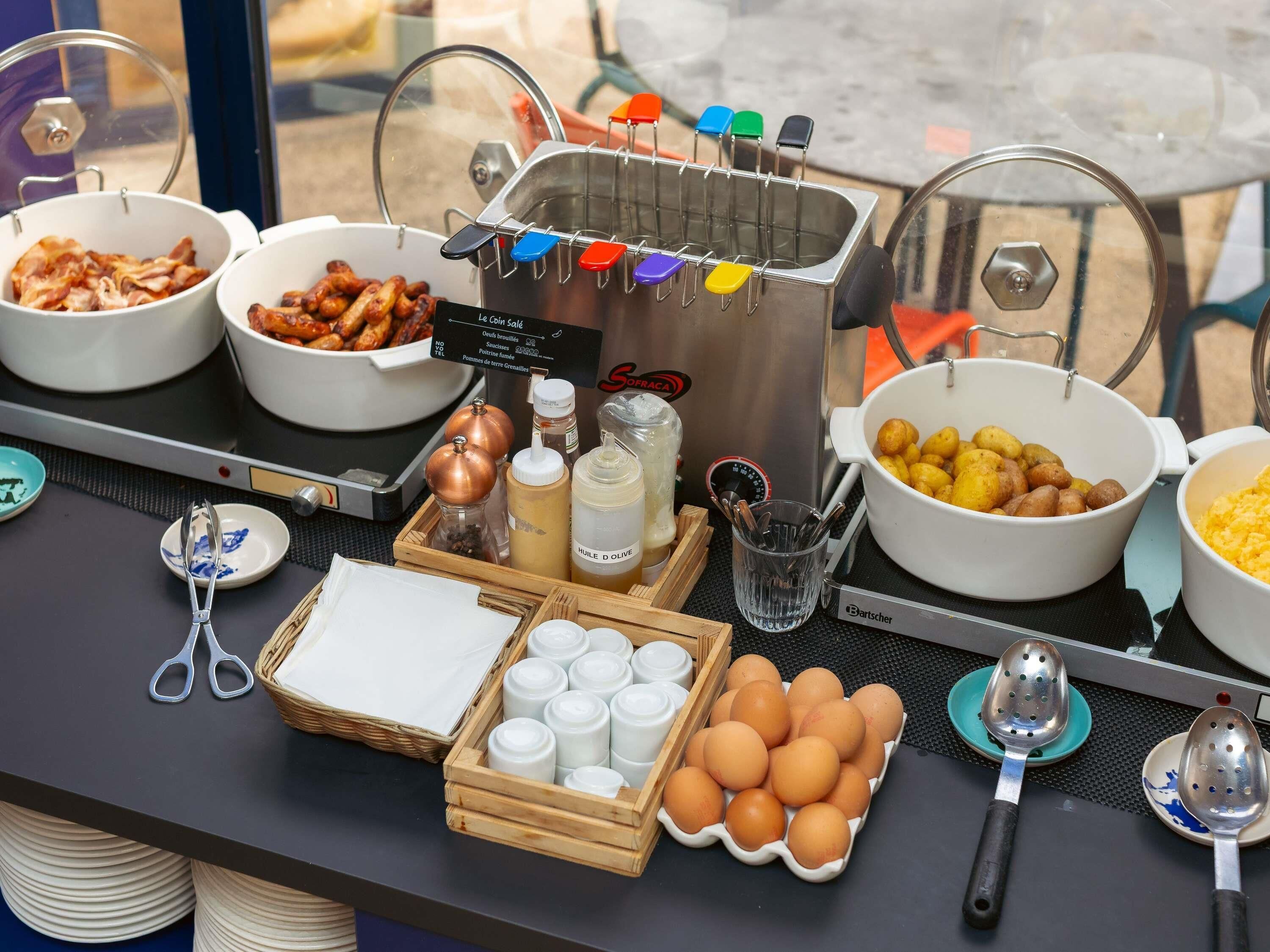 A buffet setup with various food items and condiments.