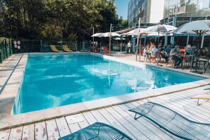 Seasonal outdoor pool, open 9:00 AM to 9:00 PM, pool umbrellas