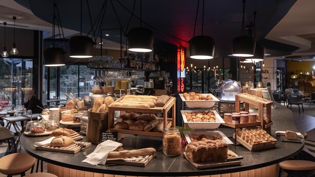 A breakfast buffet with various breads, pastries, and spreads. - Novotel La Rochelle Centre (La Rochelle)