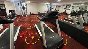 A gym with treadmills, elliptical machines, and a stationary bike. - Clarion Inn I-94 near Expo Center (Kalamazoo)