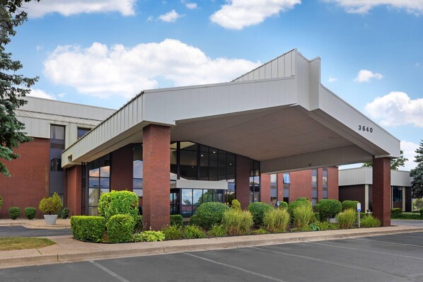 A modern building with a covered entrance, numbered 3640, featuring a brick facade and large windows.