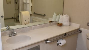 A bathroom with a sink, mirror, towel rack, and toilet.