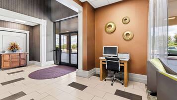 A reception area with a desk, computer, and decorative wall accents.