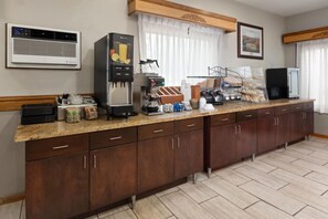 A kitchen with a coffee machine, a refrigerator, and a microwave. - Travelodge by Wyndham Ishpeming/Marquette (Ishpeming)