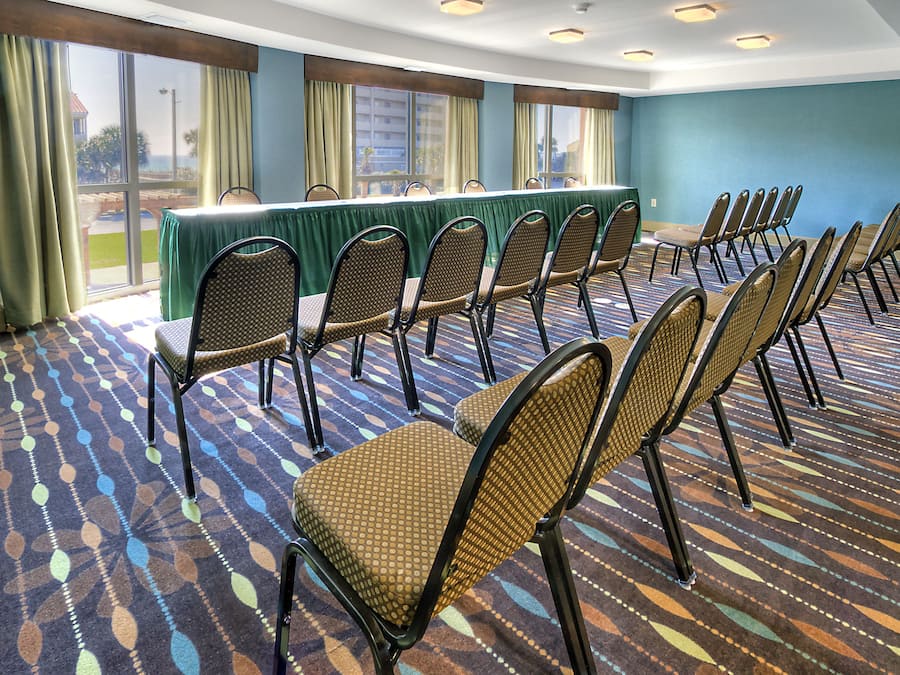 A conference room with a long table and chairs arranged for meetings.