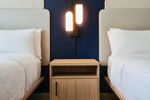 A hotel room with two beds, a nightstand, and a wall-mounted light fixture. - Hampton Inn & Suites Destin (Destin)