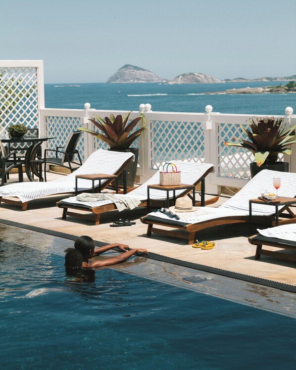 Outdoor pool, open 7:00 AM to 7:00 PM, pool umbrellas, sun loungers
