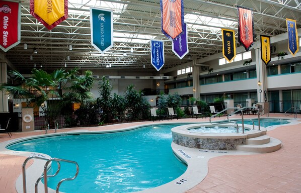 Relax by the pool surrounded by lush greenery and comfortable seating areas.
