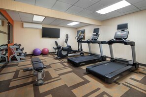 A fitness room with treadmills, a bench, dumbbells, and exercise balls. - Courtyard Fremont Silicon Valley (Fremont)