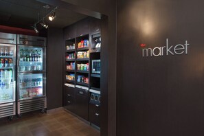 A vending machine area with snacks and beverages, and a refrigerated section with drinks. - Courtyard Fremont Silicon Valley (Fremont)