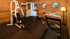A gym with exercise equipment, a treadmill, and a mirror on the wall. - Red Lion Hotel & Conference Center Ellensburg (Ellensburg)