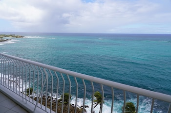 Enjoy breathtaking ocean views from this balcony with a curved railing. at The Condado Plaza Hotel
