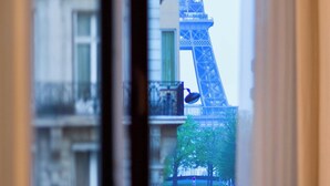 A view of the Eiffel Tower through a window with a curtain. - Le Metropolitan Paris Tour Eiffel, a Tribute Portfolio Hotel (Paris)
