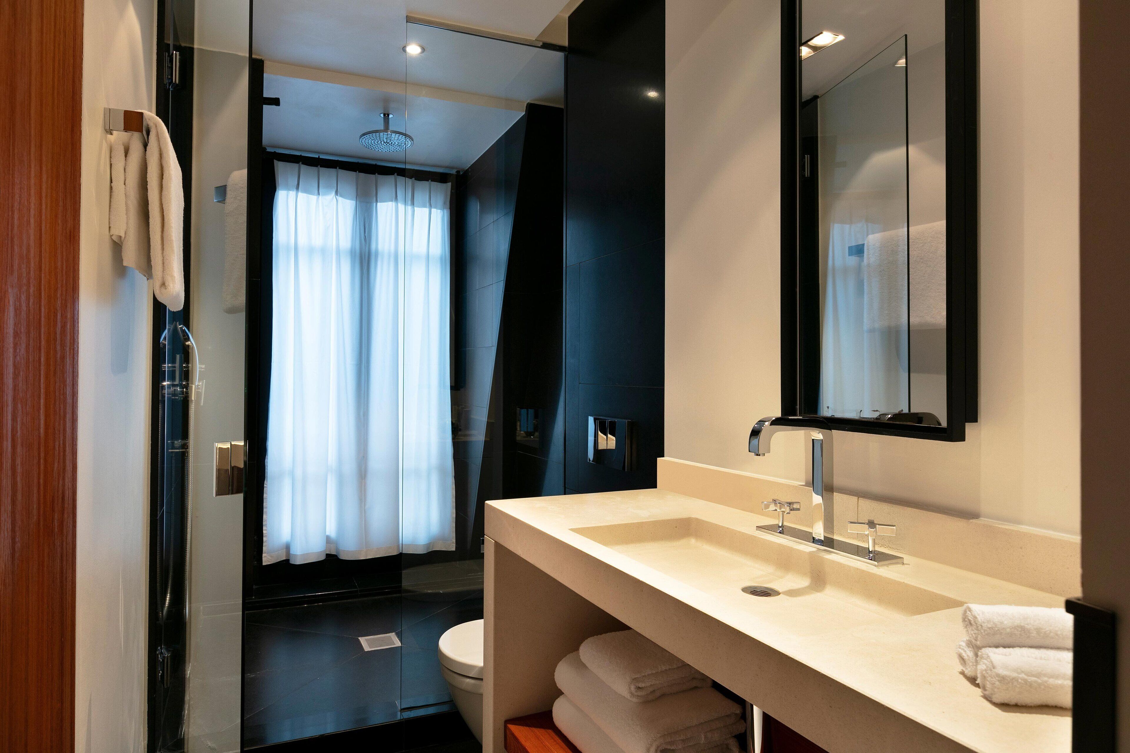 combined shower/bathtub, designer toiletries, hair dryer, bathrobes