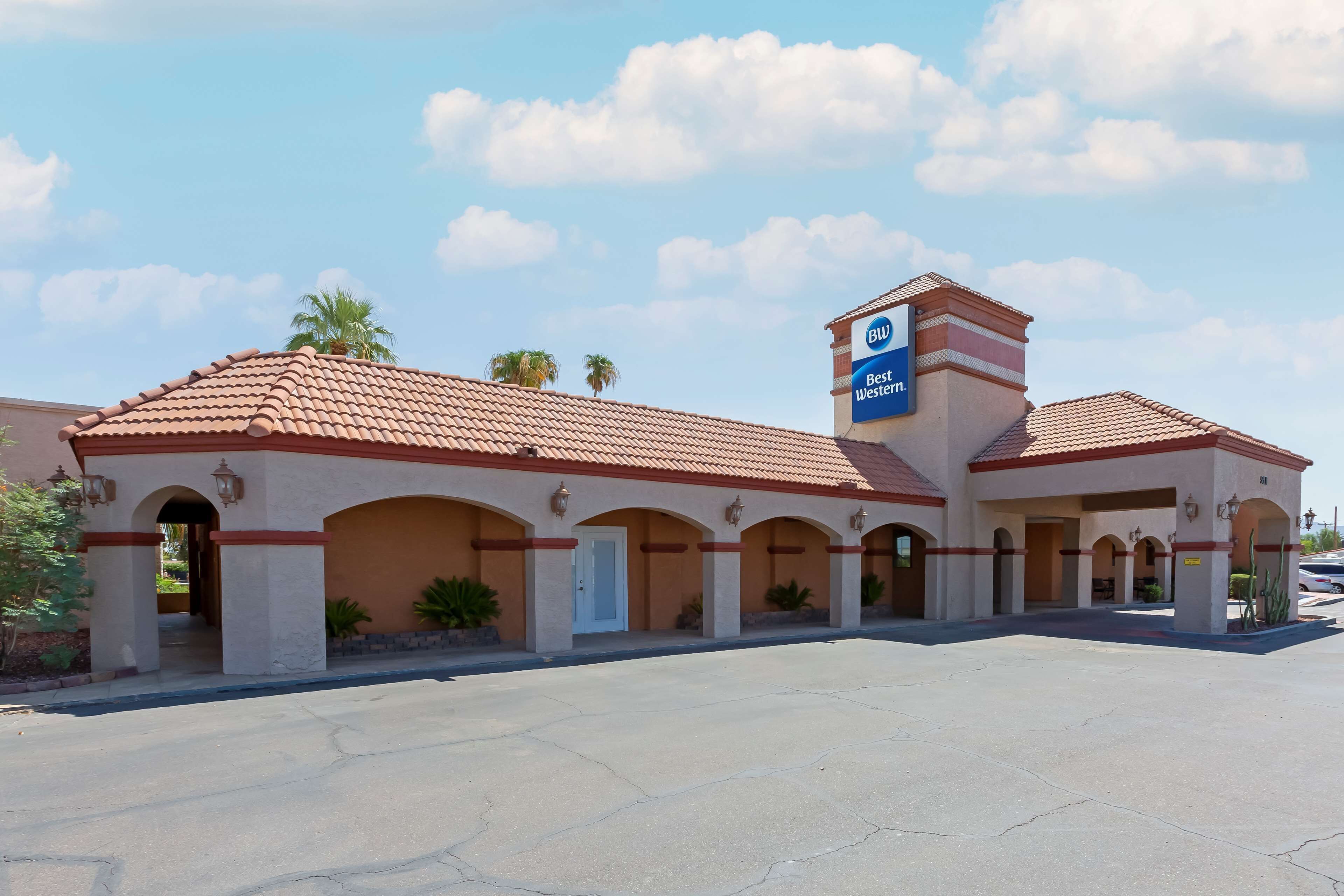 A hotel with a red-tiled roof, multiple arches, and a sign indicating it is a Best Western hotel.