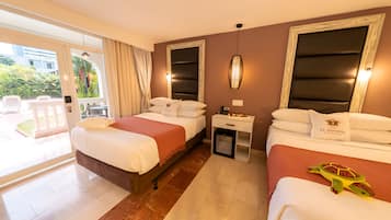 Habitación de hotel con dos camas, un escritorio pequeño y vistas al exterior.