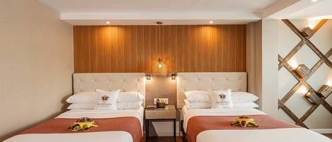 A hotel room with two beds, wooden paneling on the wall, a nightstand with a lamp, and a decorative wall piece.