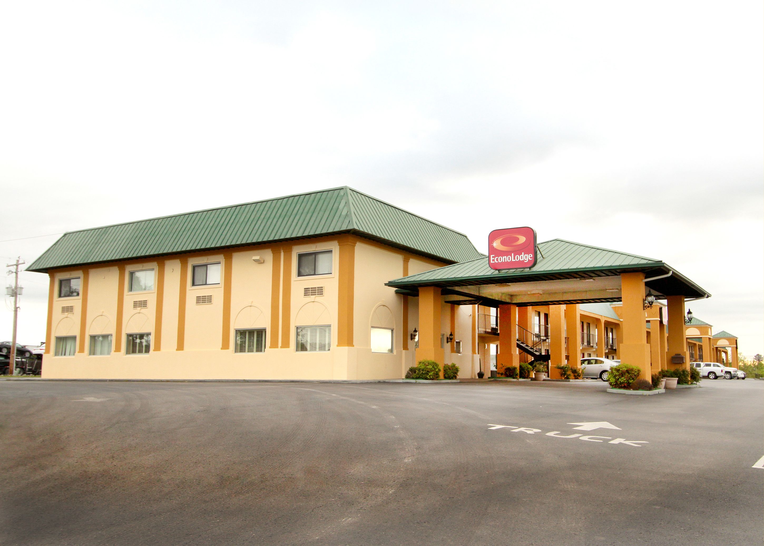 A two-story motel with a green roof and a sign for EconoLodge.