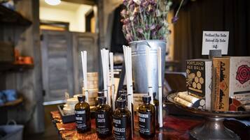 A display of candles and essential oils on a wooden counter.