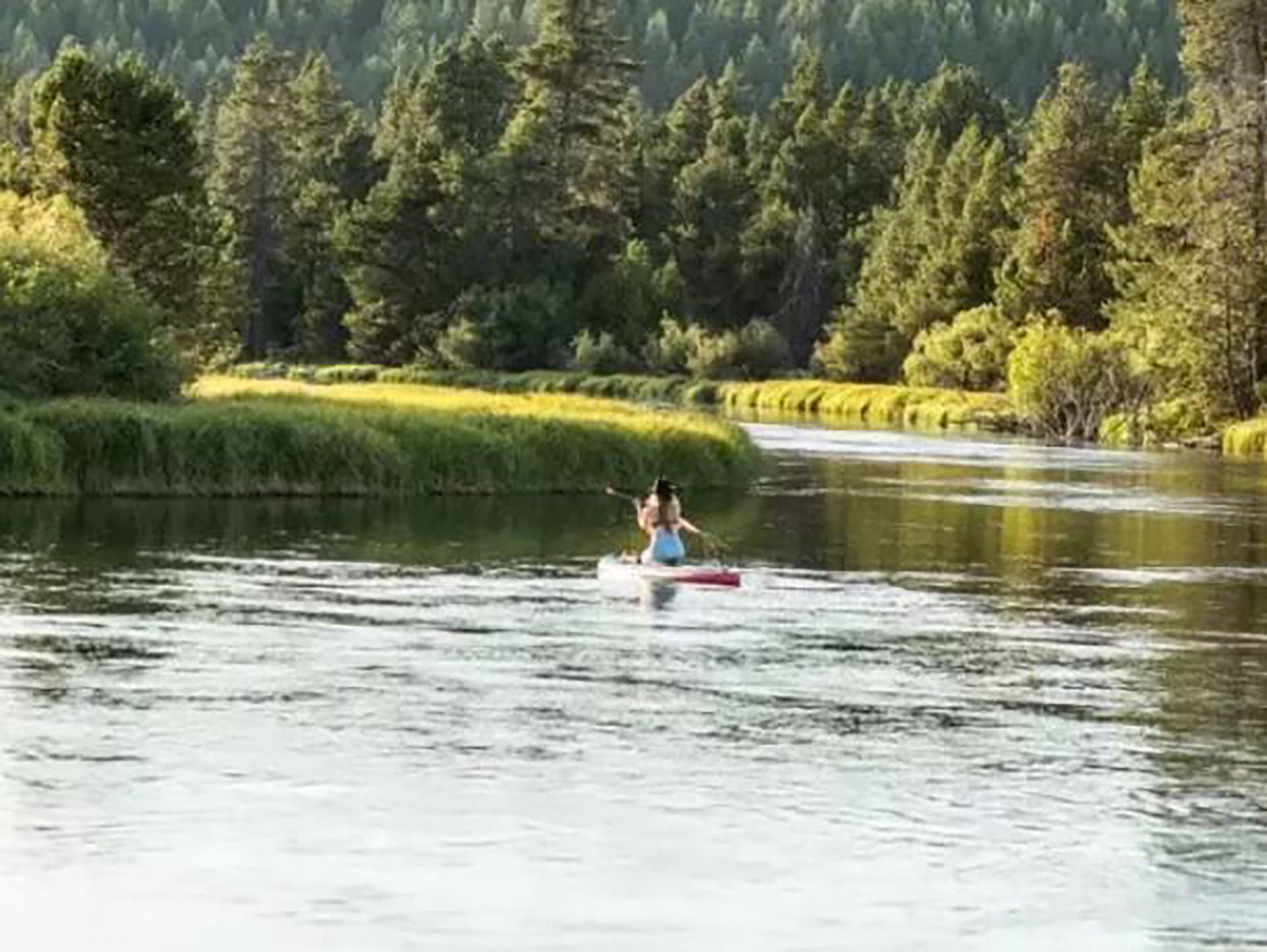 A river with a person kayaking.