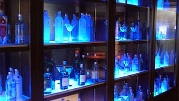 A display of various liquor bottles in glass cases.
