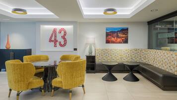 A modern interior with a dining area, a sofa, and a wall with a large number '43'.