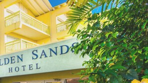 A hotel with a sign reading "Golden Sands Hotel". - Golden Sands Hotel (Oistins)