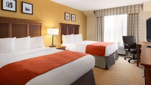 A hotel room with two beds, a desk, a chair, and a television. - Country Inn & Suites by Radisson, Holland, MI (Holland)