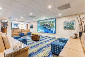 A hotel lobby with a large window, seating area, and artwork on the walls. - Holiday Inn Key Largo by IHG (Key Largo)