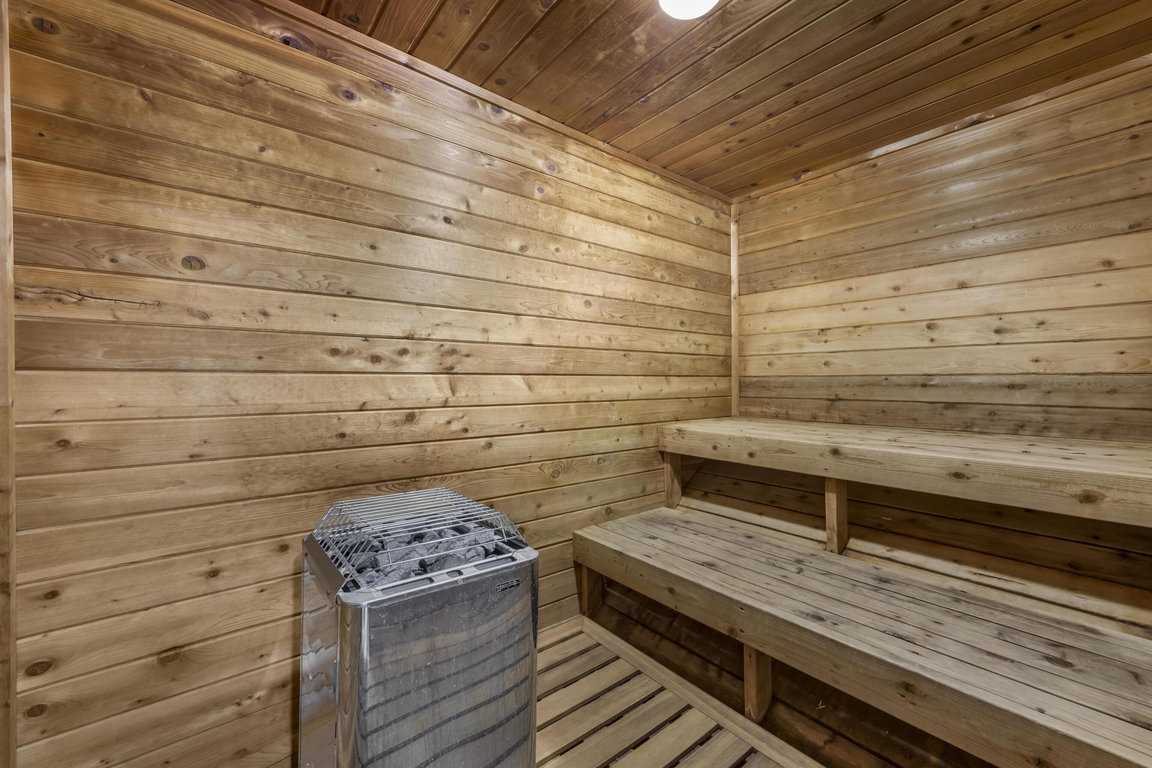 A sauna room with wooden walls and benches.