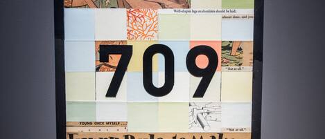 A bulletin board with various notes and a large number '709' prominently displayed.
