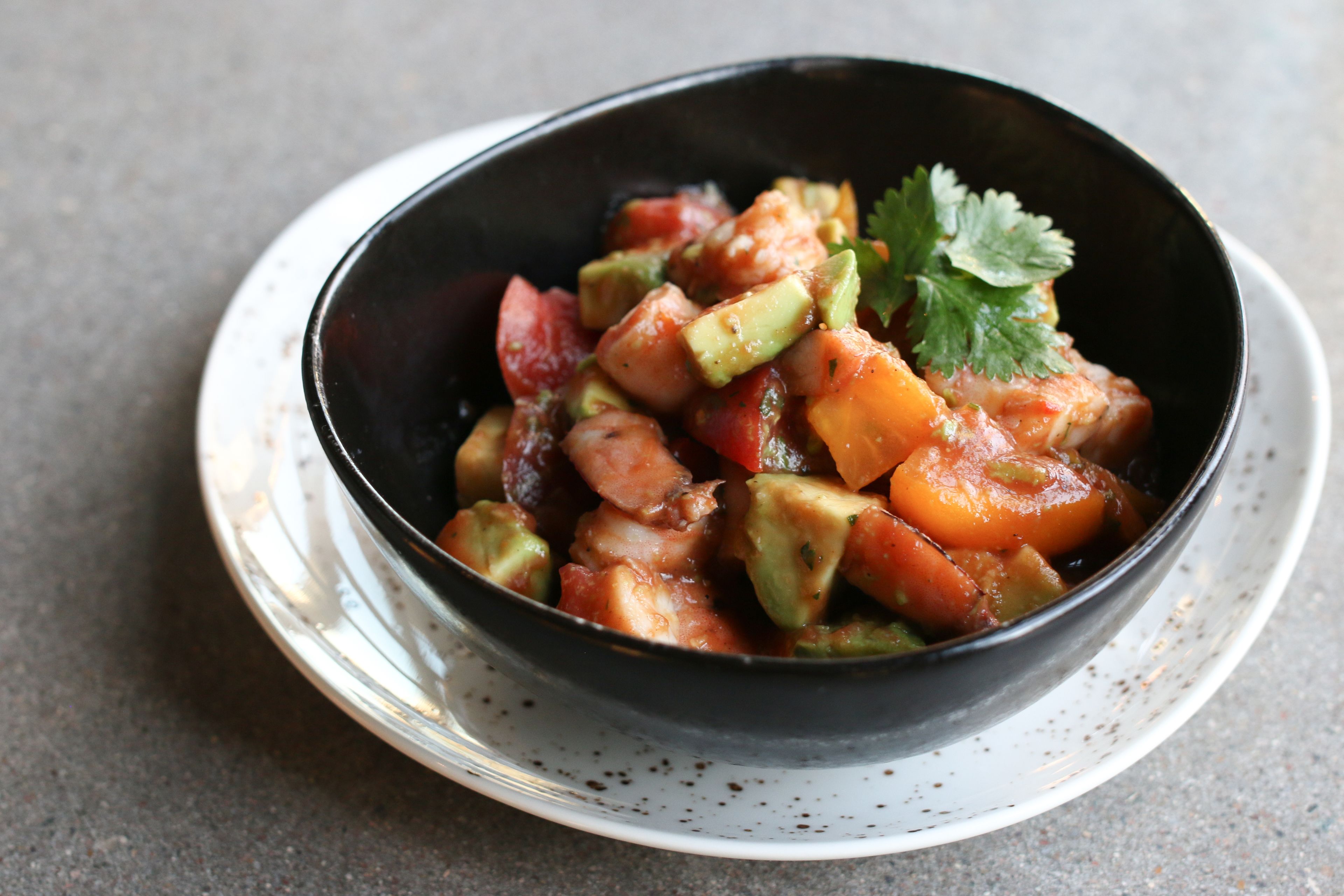A bowl of food on a plate.