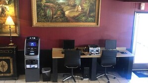 A room with a desk, two chairs, a computer, a printer, and a water dispenser. - Days Inn by Wyndham Abilene (Abilene)