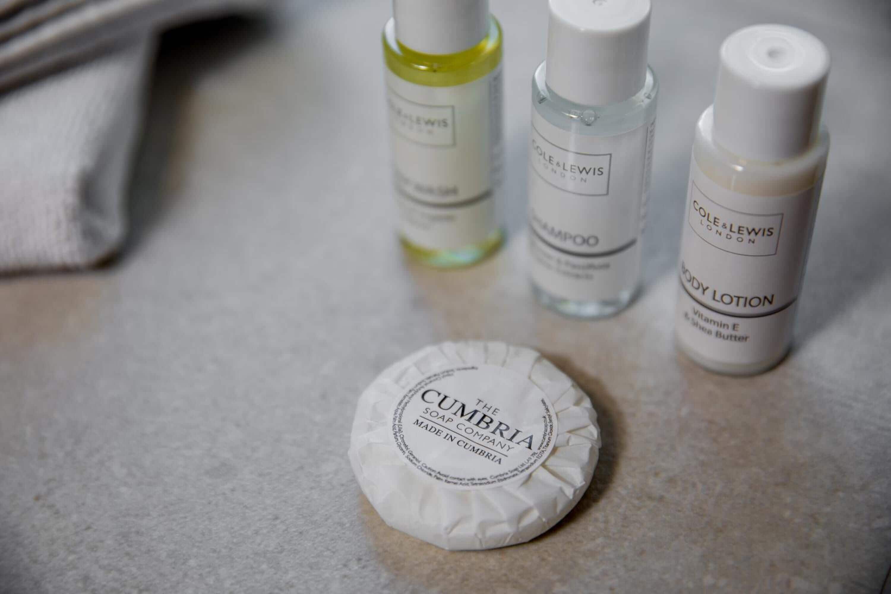 designer toiletries, hair dryer, towels, soap