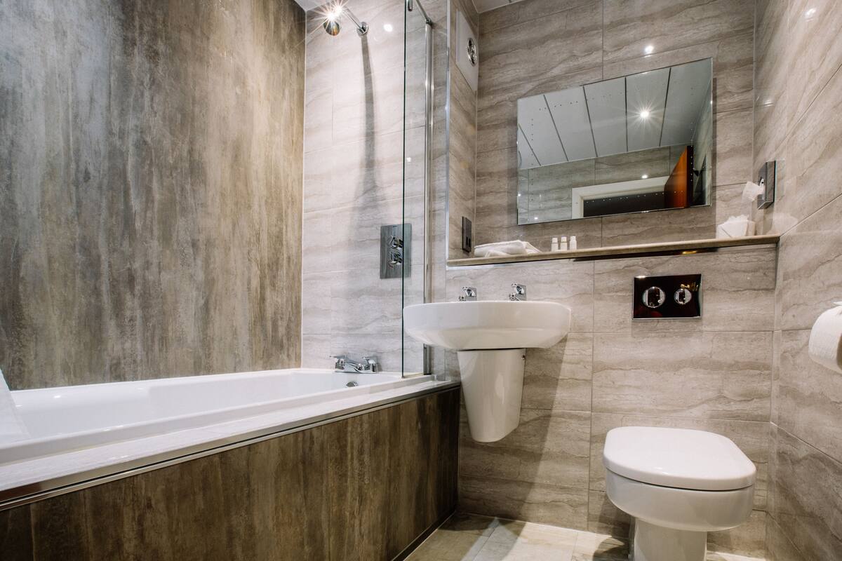 designer toiletries, hair dryer, towels, soap