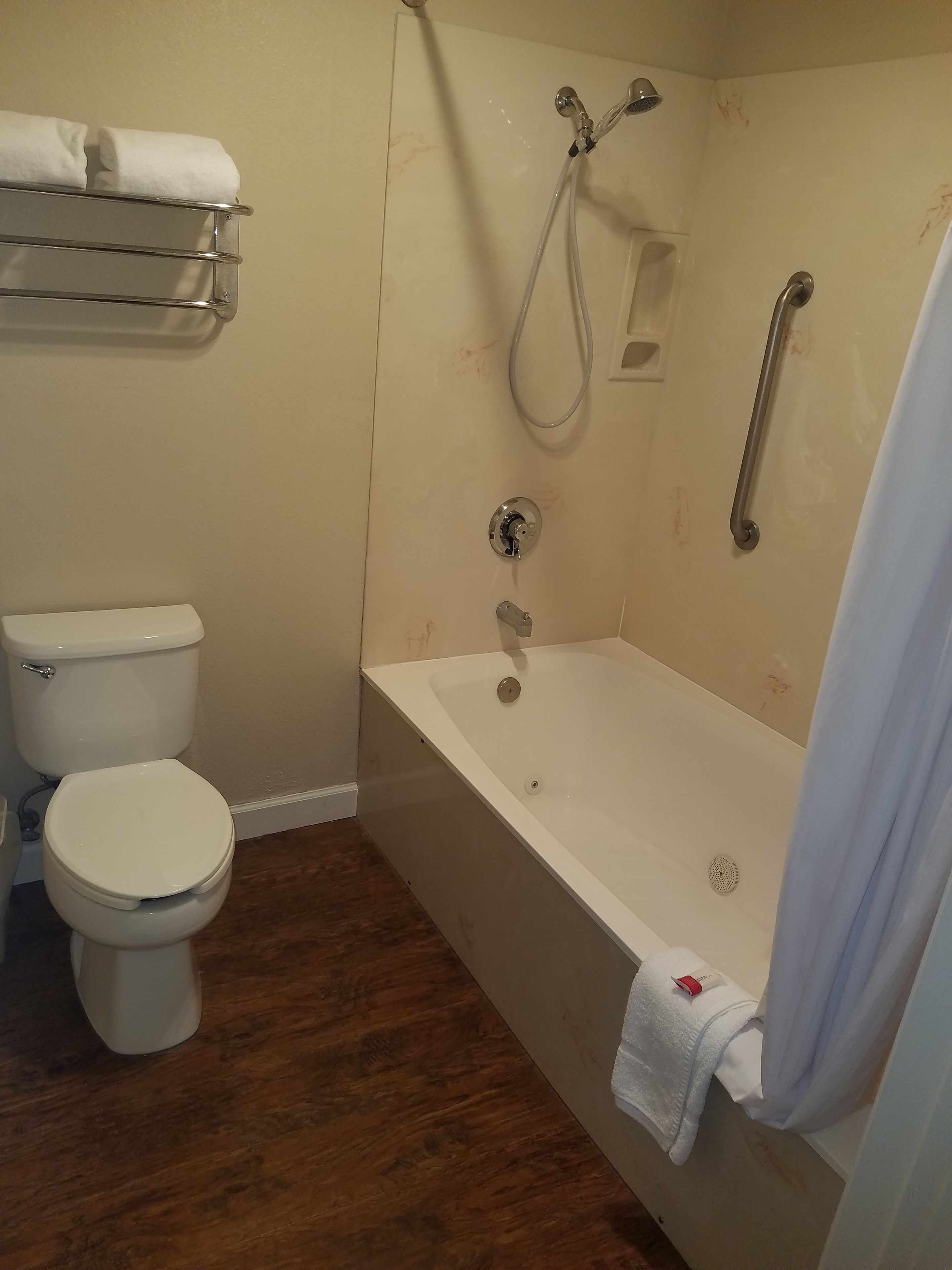 A bathroom with a toilet, a bathtub, and a shower.