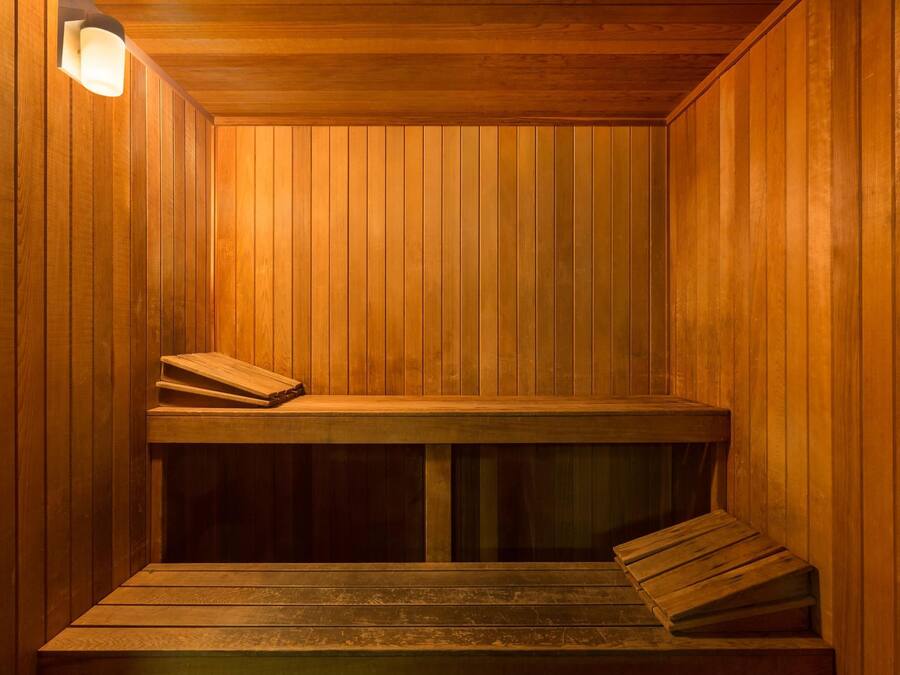 A sauna with wooden walls and benches.